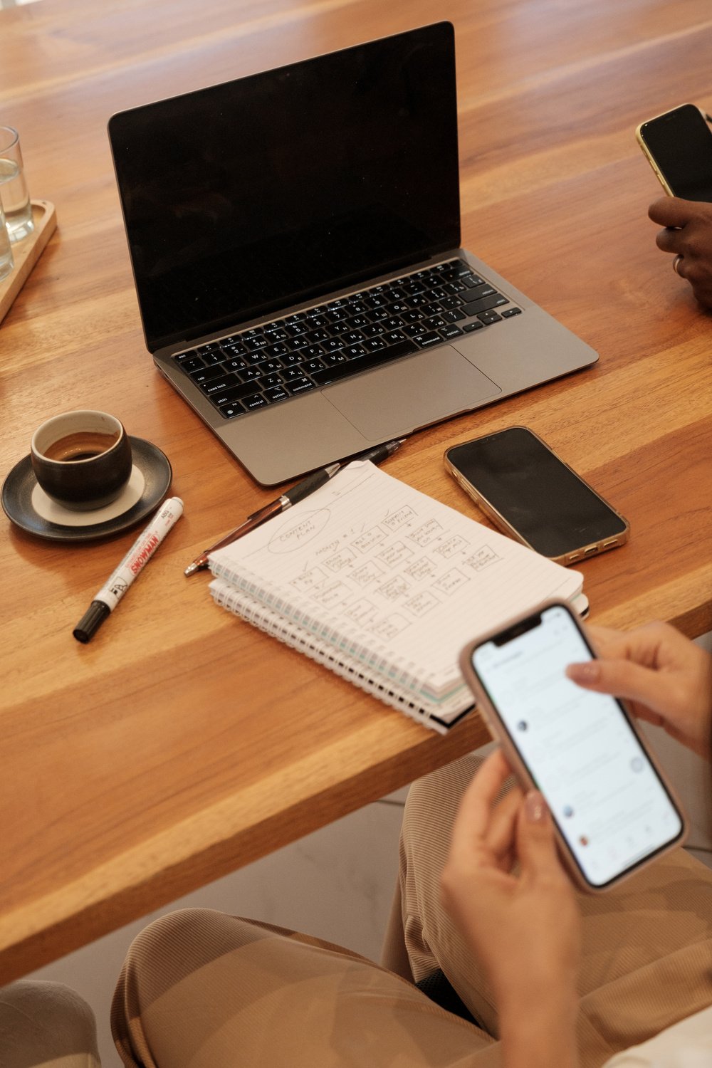 Man Working with a Laptop and Smartphone